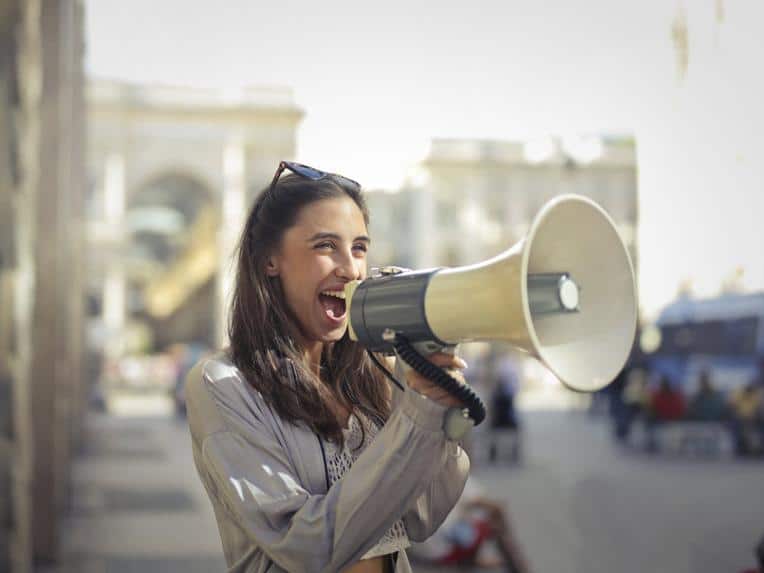 An influencer speaking into a megaphone