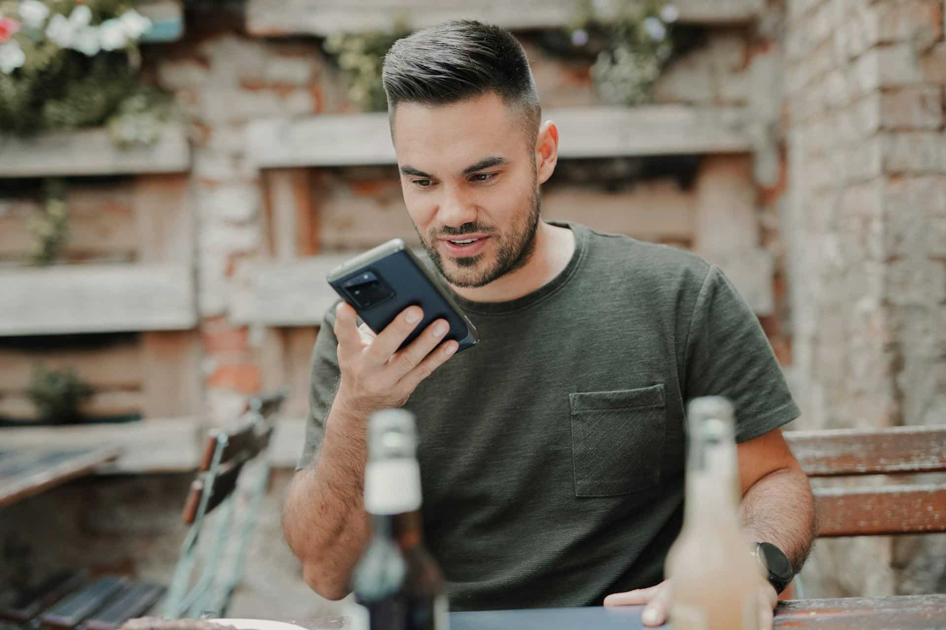 Man using his phone for a voice search.